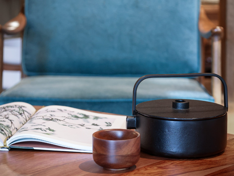 poltrona con tazza da te e teiera e libro